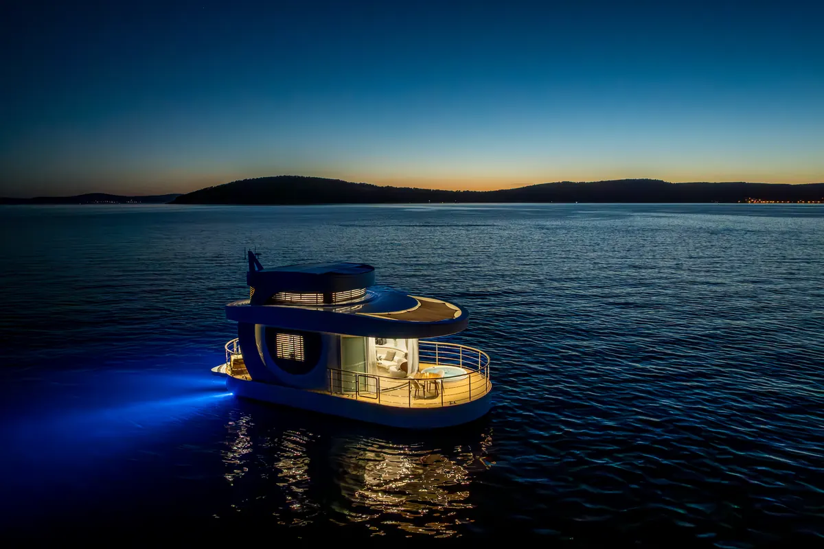 Amor alone on a wide, still sea just after sunset, lit from within